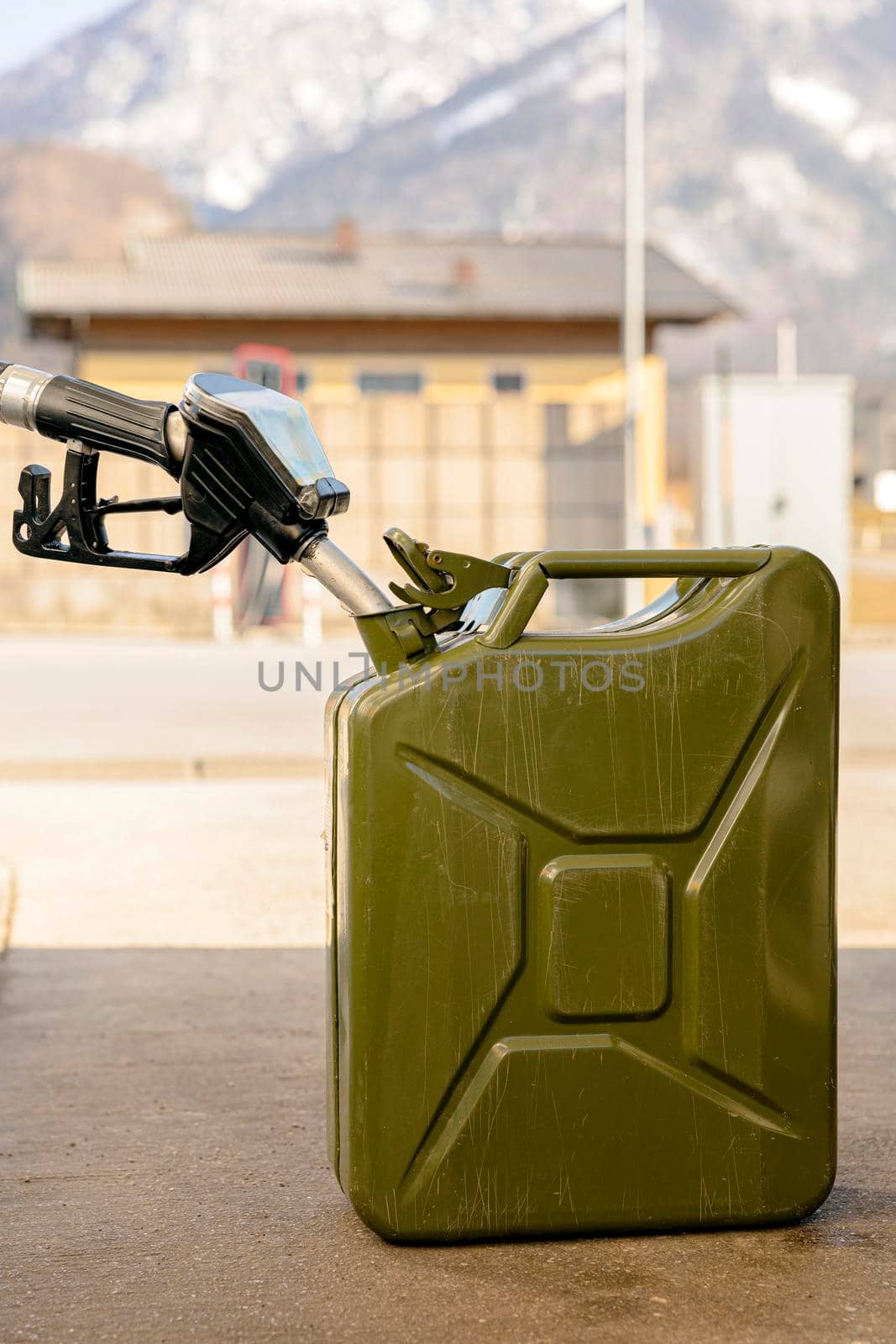 Refilling canister with fuel on the petrol station. Close up view. Fuel, gasoline, diesel is getting more expensive. Petrol industry and service. Petrol price and oil crisis concept