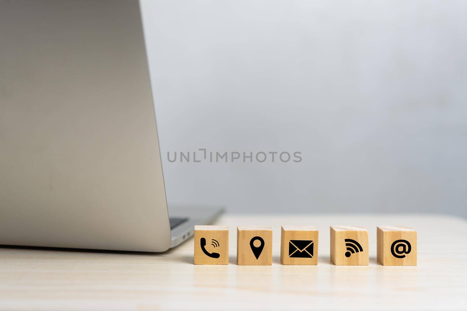 wood cube icon website page contact us or e-mail call phone, address, marketing concept on desk.