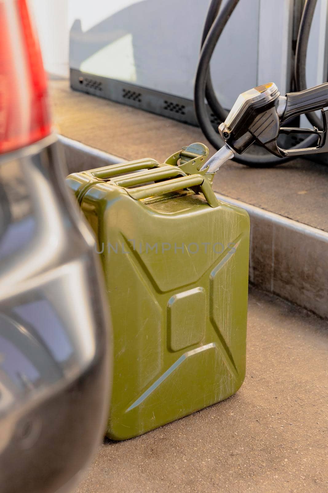Refilling canister with fuel on the petrol station. Close up view. Fuel, gasoline, diesel is getting more expensive. Petrol industry and service. Petrol price and oil crisis concept
