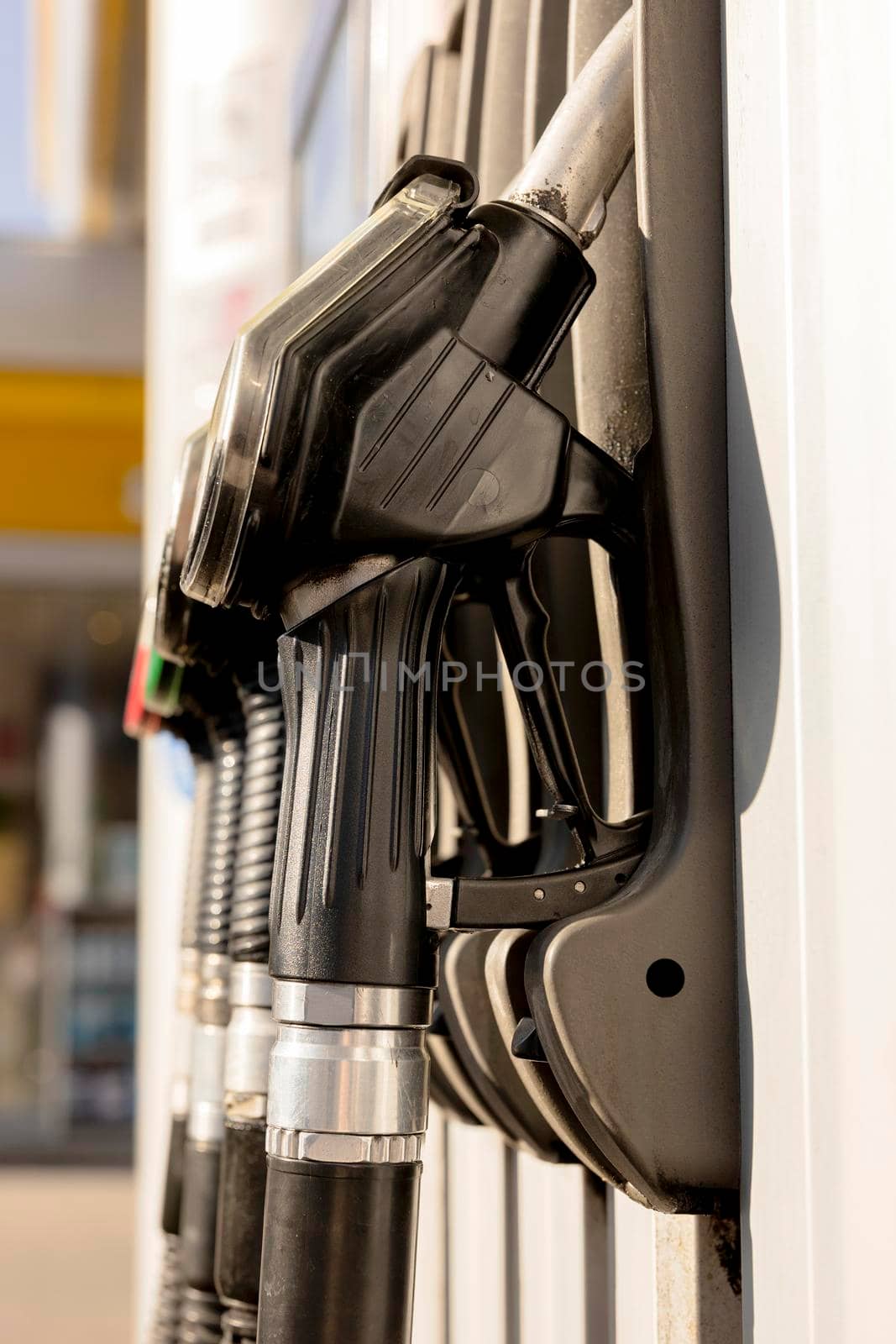 Fuel nozzles on the petrol station. Close up view. Fuel, gasoline, diesel is getting more expensive. Petrol industry and service. Petrol price and oil crisis concept