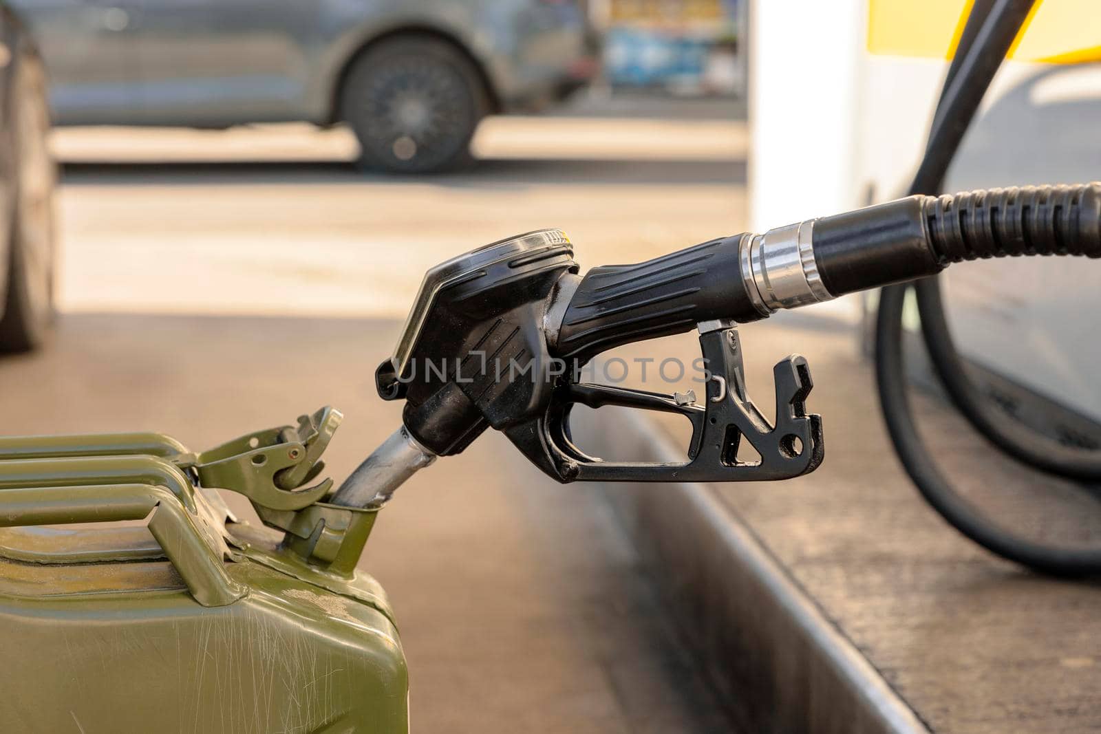 Refilling canister with fuel on the petrol station. Close up view. Fuel, gasoline, diesel is getting more expensive. Petrol industry and service. Petrol price and oil crisis concept