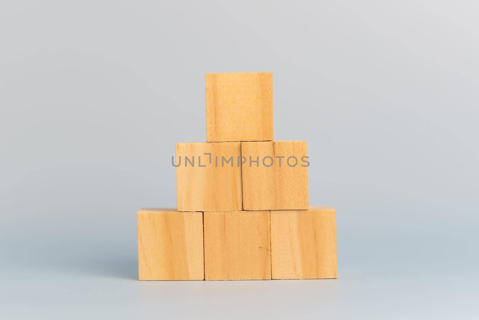 hand holding cube wood block blank on background. copy space