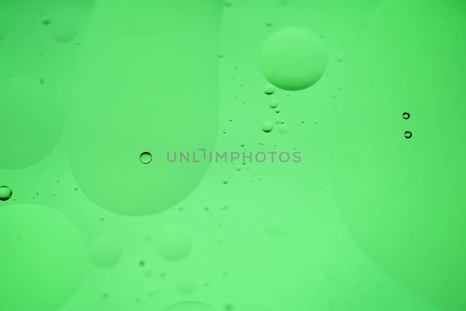 Green mint abstract background picture made with oil, water and soap by anytka