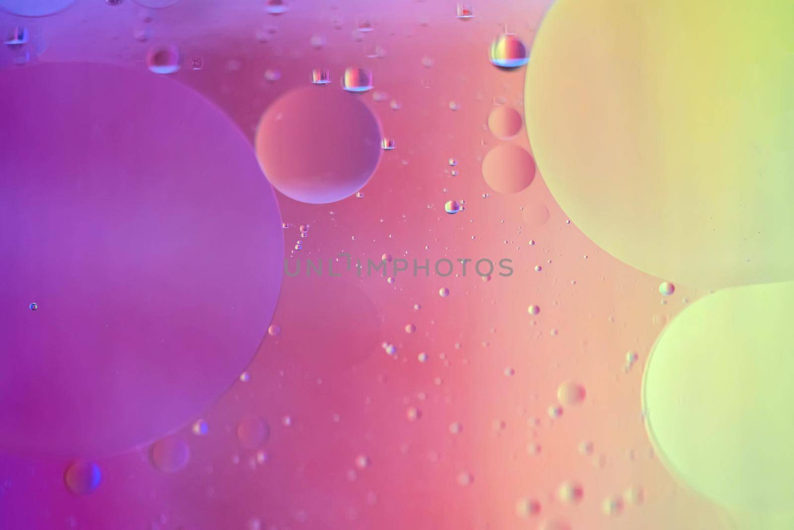 Oil drops in water. Abstract defocused psychedelic pattern image rainbow colored. Abstract background with colorful gradient colors. DOF.