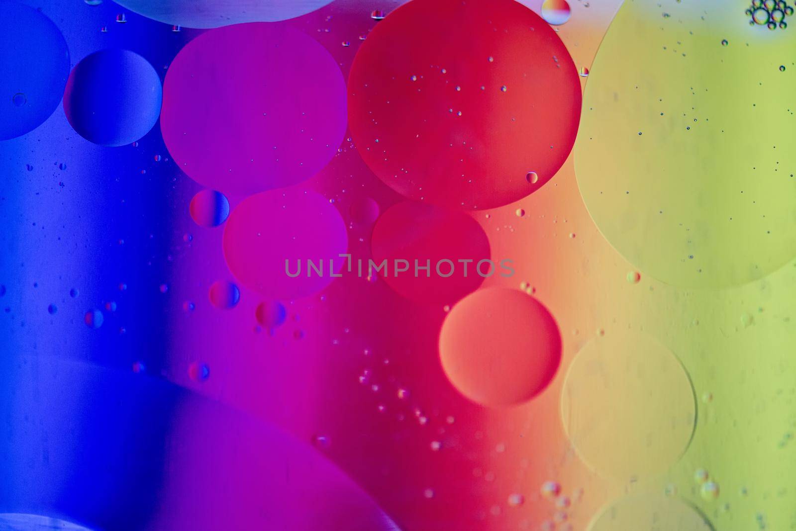 Oil drops in water. Abstract defocused psychedelic pattern image rainbow colored. Abstract background with colorful gradient colors. DOF