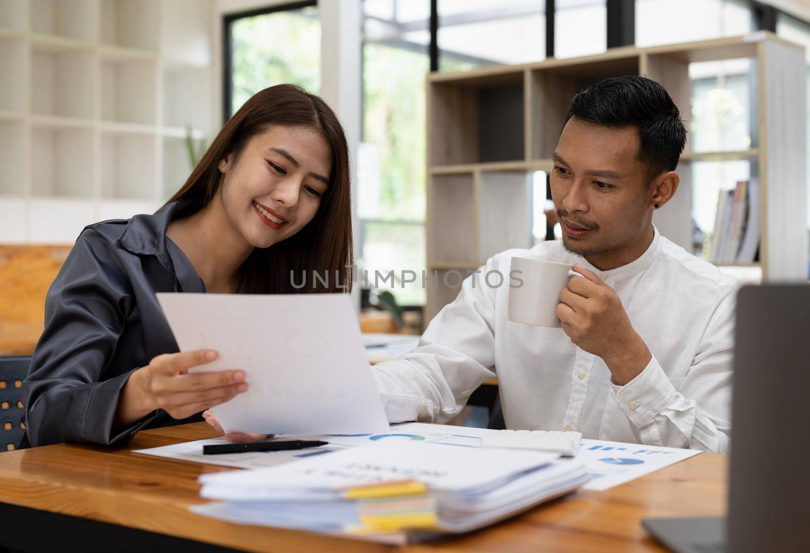 Asian business adviser meeting to analyze and discuss the situation on the financial report in the meeting room.Investment Consultant, Financial advisor and accounting concept.
