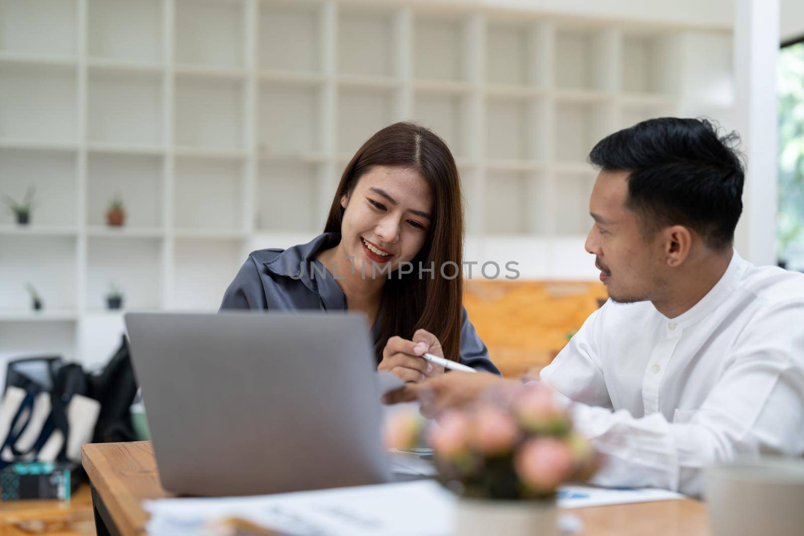 Asian business adviser meeting to analyze and discuss the situation on the financial report in the meeting room.Investment Consultant, Financial advisor and accounting concept.