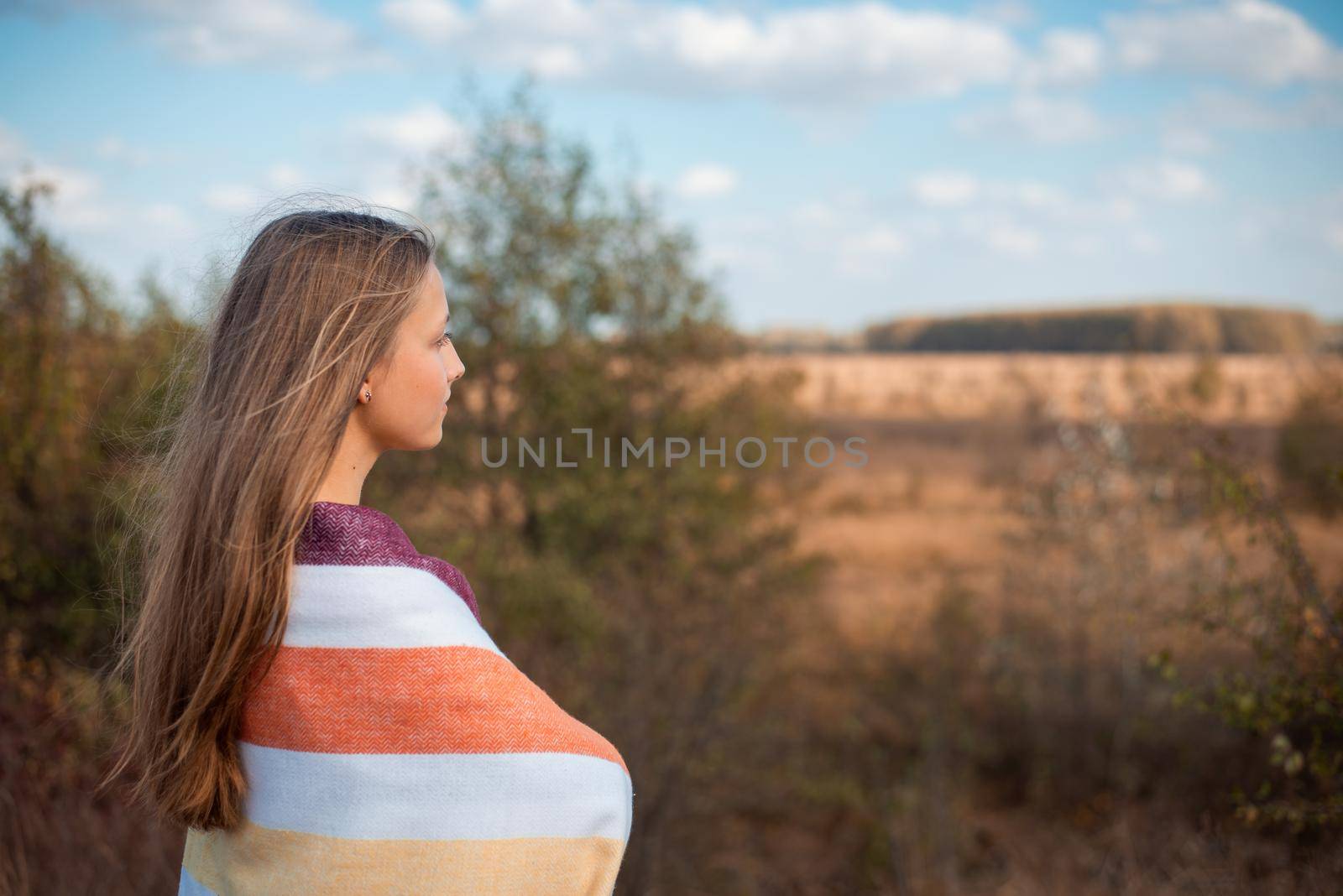 Beautiful girl admiring warm autumn weather, having a walk on nature