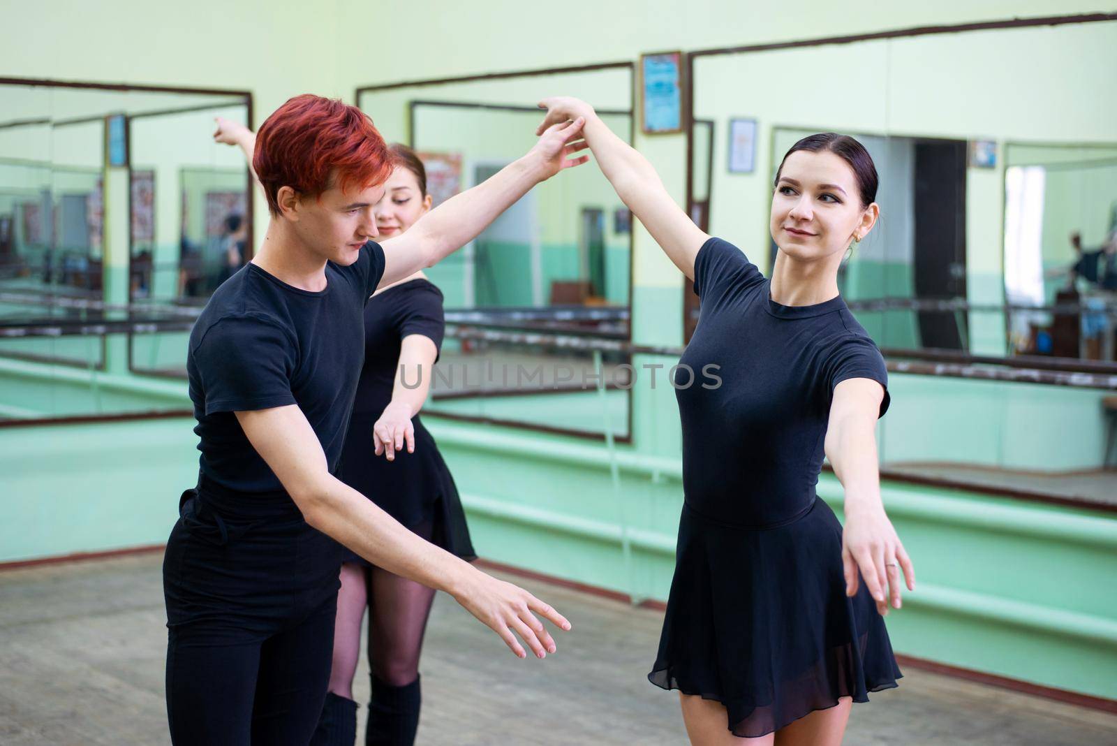 Ballet dancers are doing exercises with their teacher by VitaliiPetrushenko