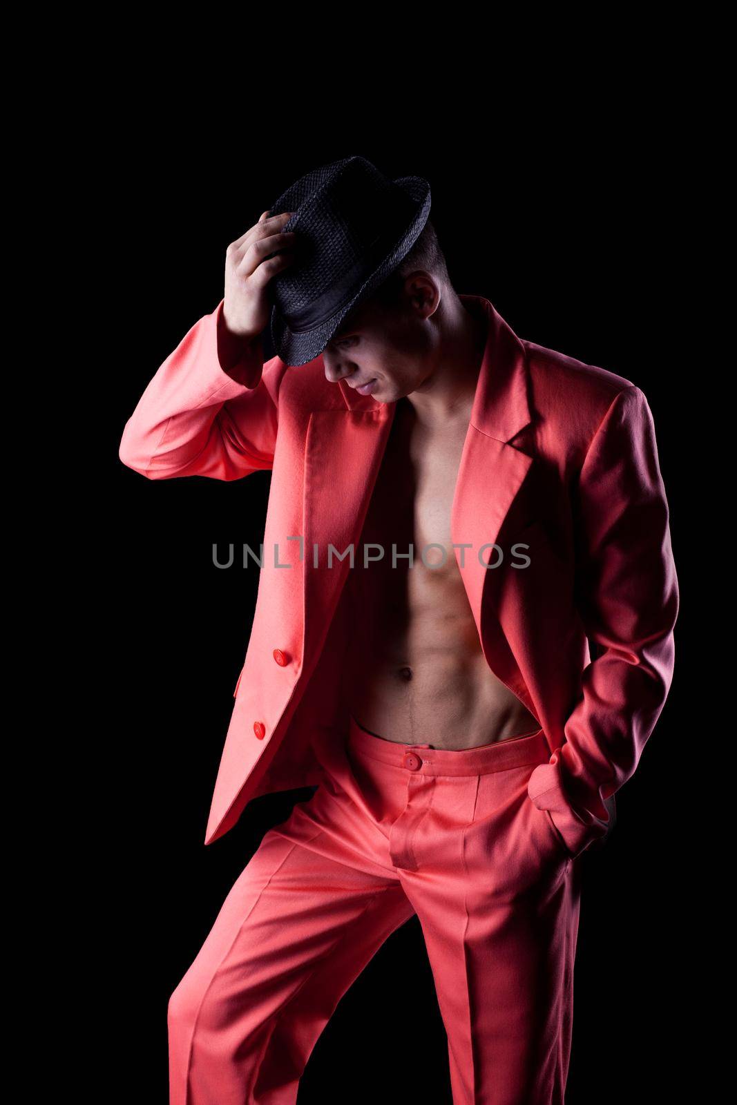 Sexy man in red suit Dancer on black background