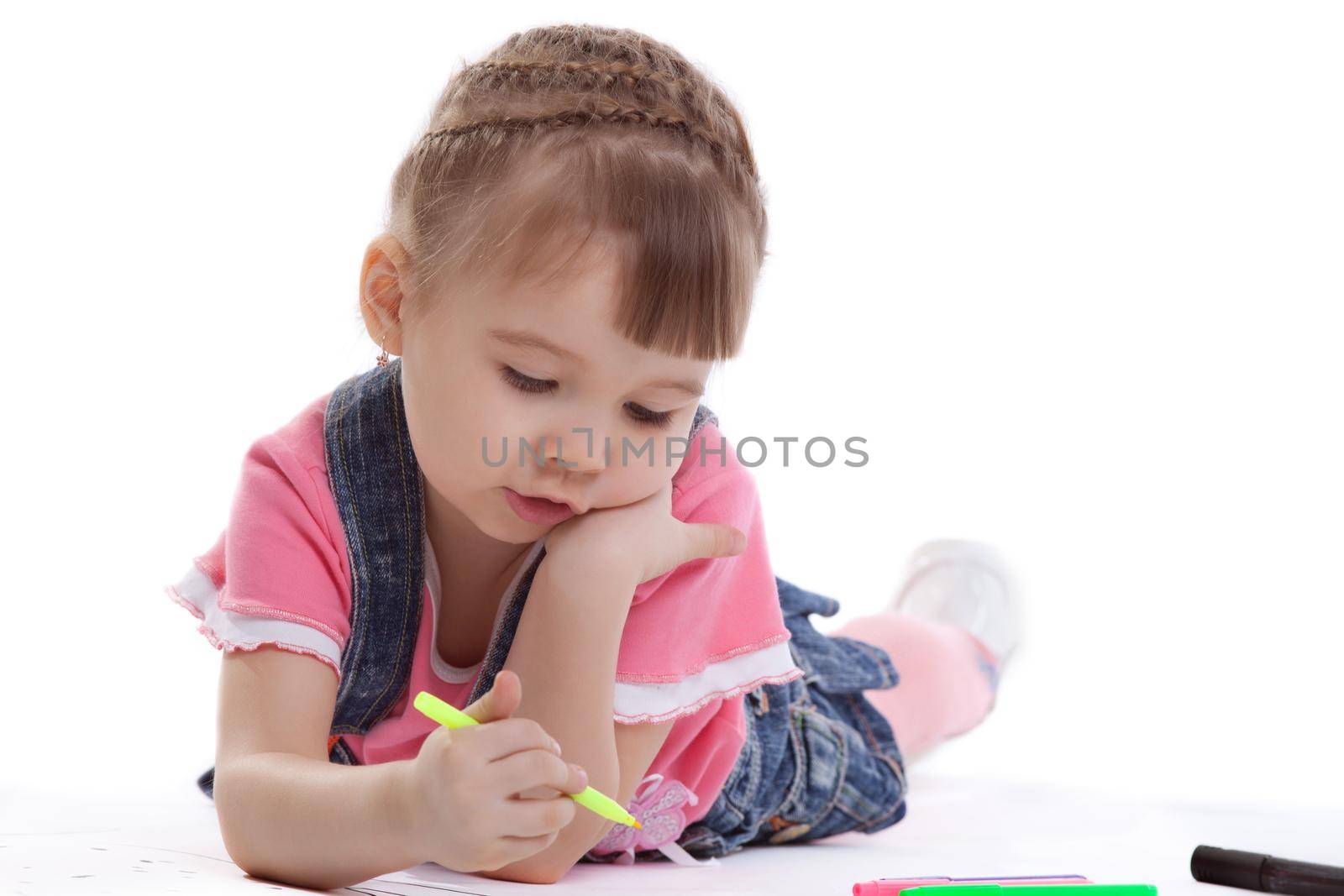 Little girl drawing on floor. Isolated on white