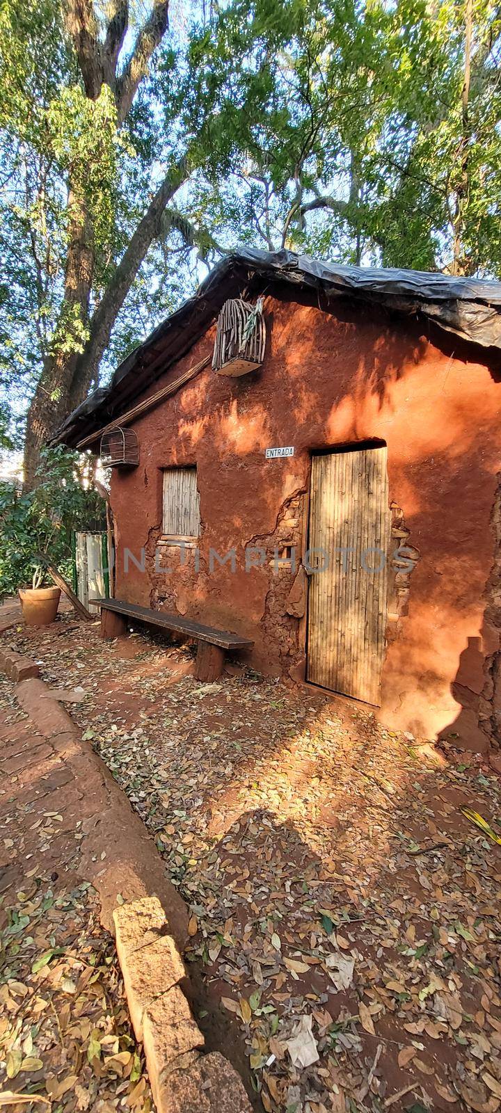 old clay house made of thatch, in Brazil with earthy colors