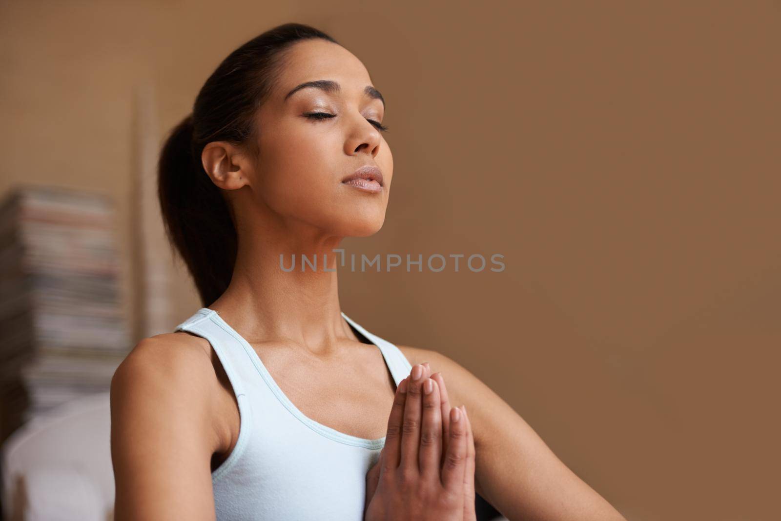 Getting centered. An attractive young woman practising the art of meditation. by YuriArcurs