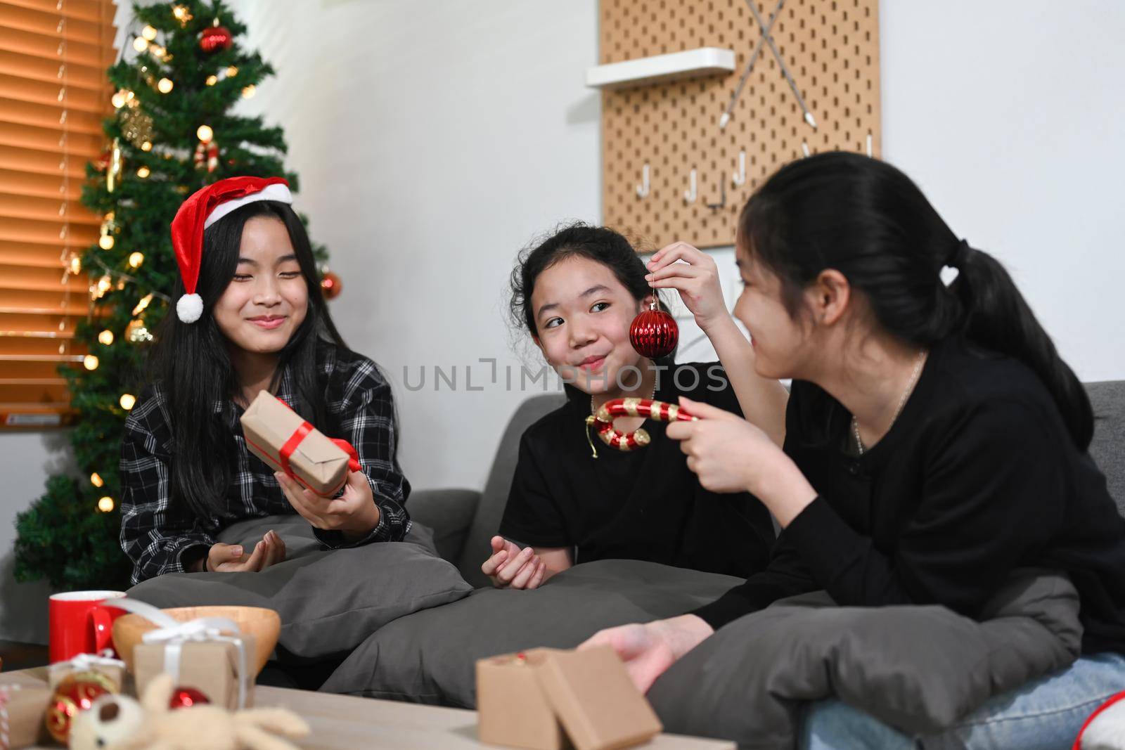 Group of asian children having fun to celebrating Christmas at home. by prathanchorruangsak