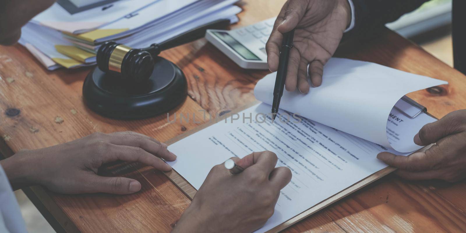 business people and lawyers discussing contract papers sitting at the table. Concepts of law, advice, legal services.