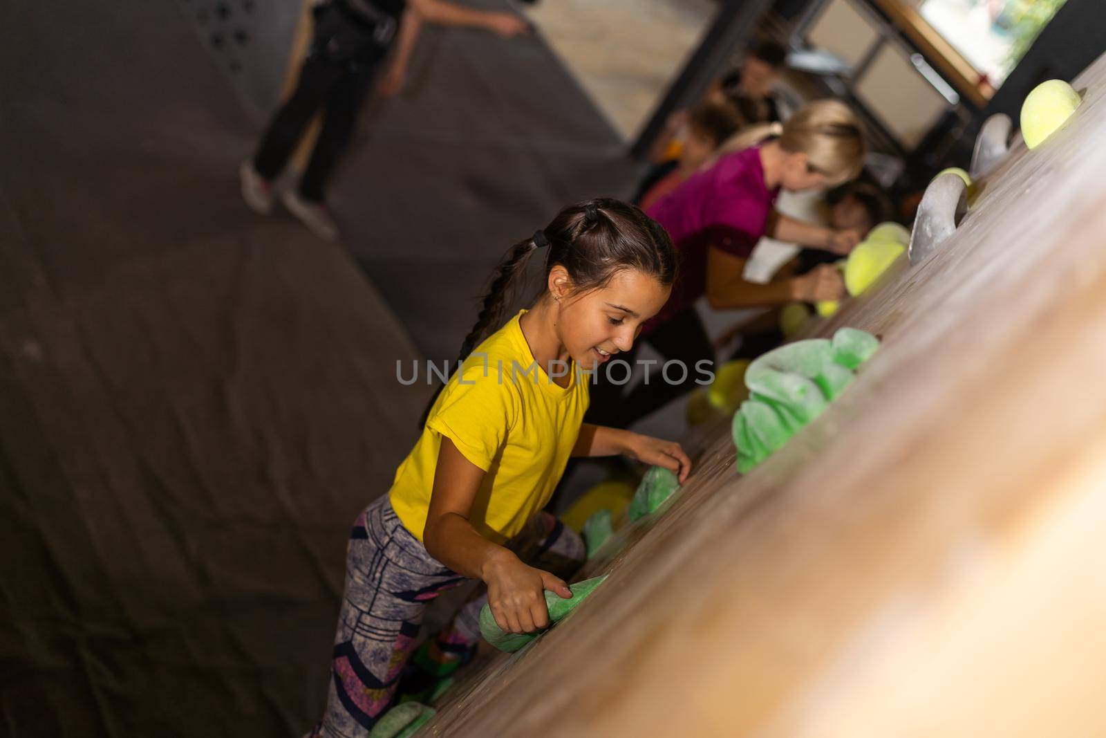 mother and daughter climb on the climbing wall. Family sport, healthy lifestyle, happy family.