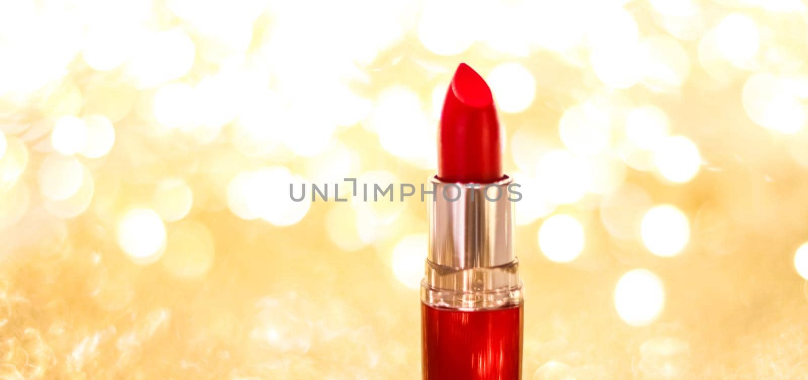 Cosmetic branding, sale and glamour concept - Red lipstick on golden Christmas, New Years and Valentines Day holiday glitter background, make-up and cosmetics product for luxury beauty brand