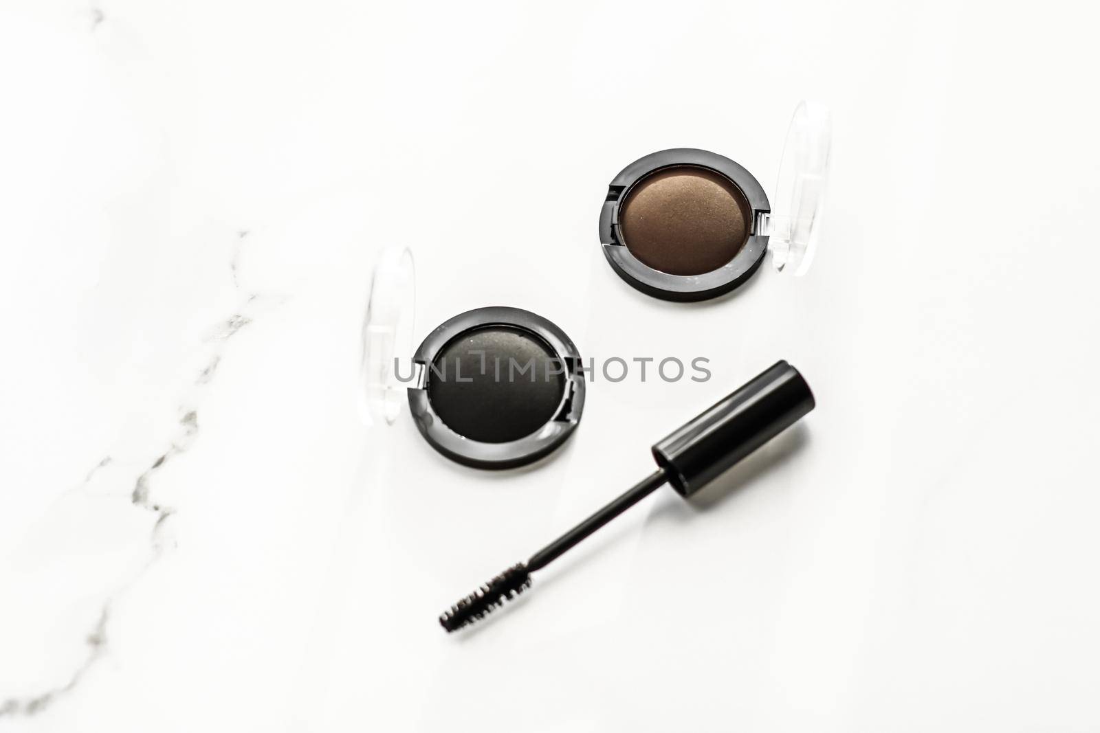 Eyeshadows, black liner and mascara on marble background, eye shadows cosmetics as glamour make-up products for luxury beauty brand, holiday flatlay design by Anneleven