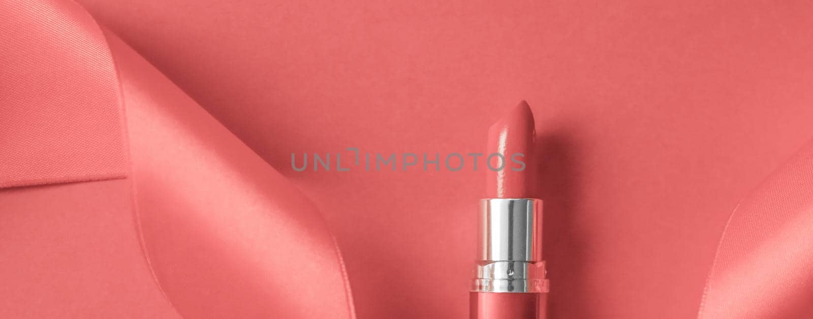 Cosmetic branding, glamour lip gloss and shopping sale concept - Luxury lipstick and silk ribbon on coral holiday background, make-up and cosmetics flatlay for beauty brand product design