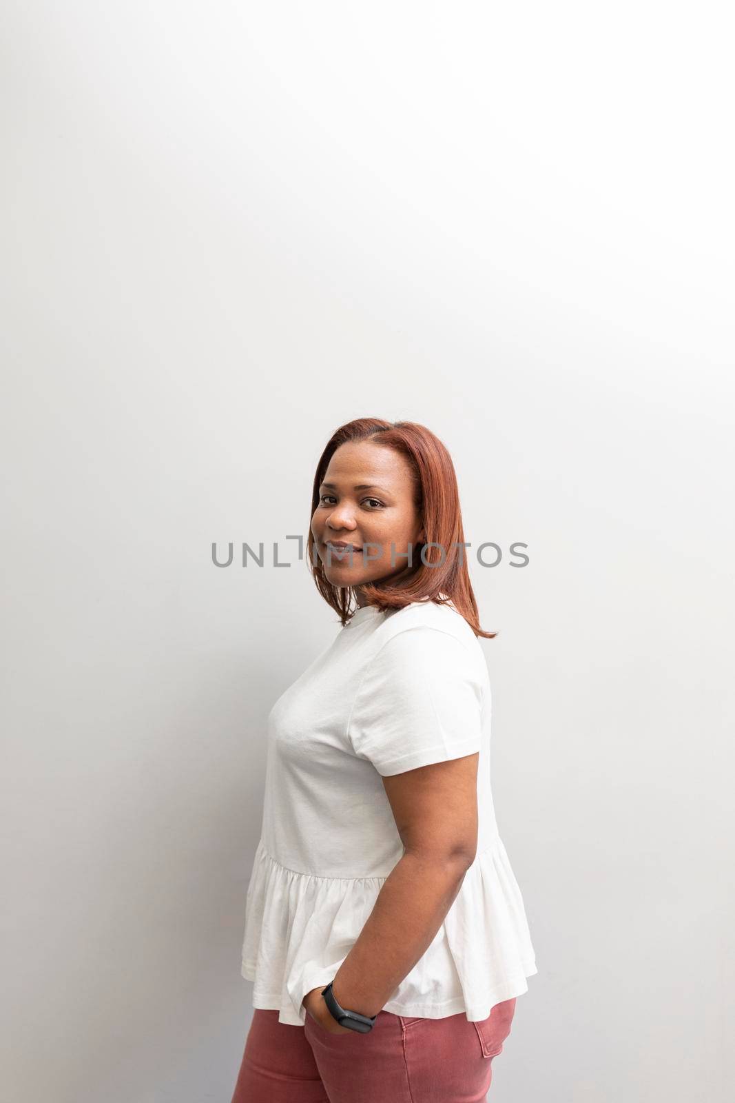 A black woman smiling at the dental clinic by stockrojoverdeyazul