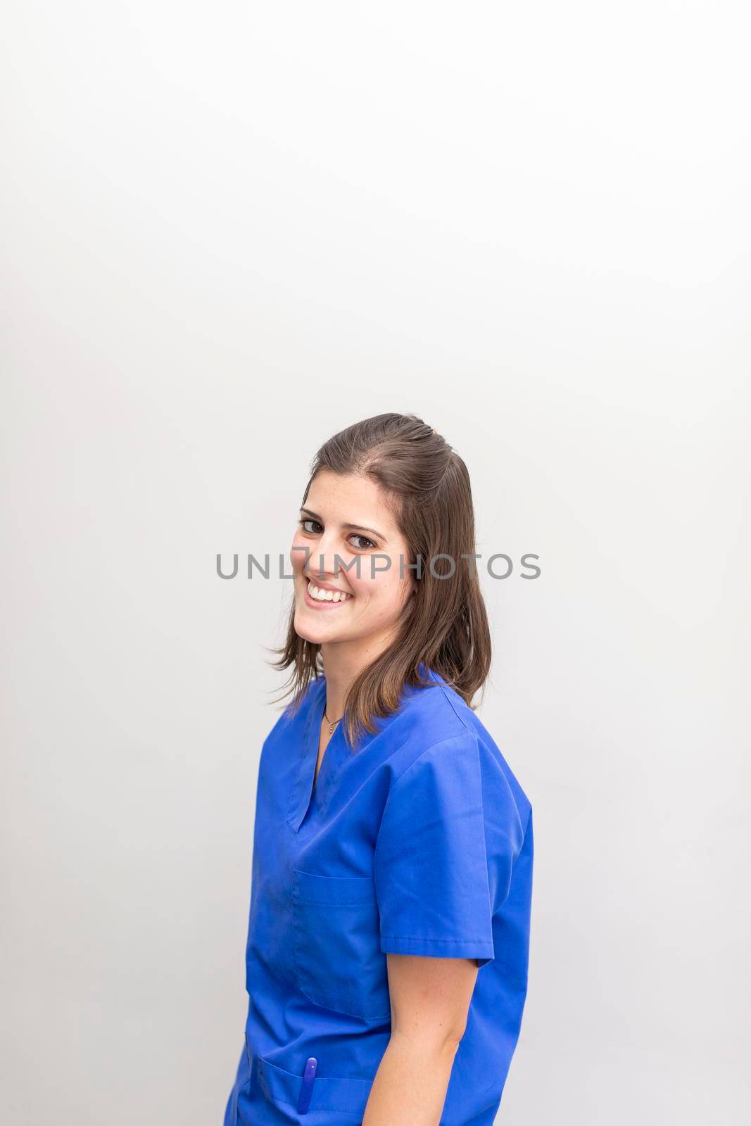 A dentist woman, smiling at the dental clinic by stockrojoverdeyazul