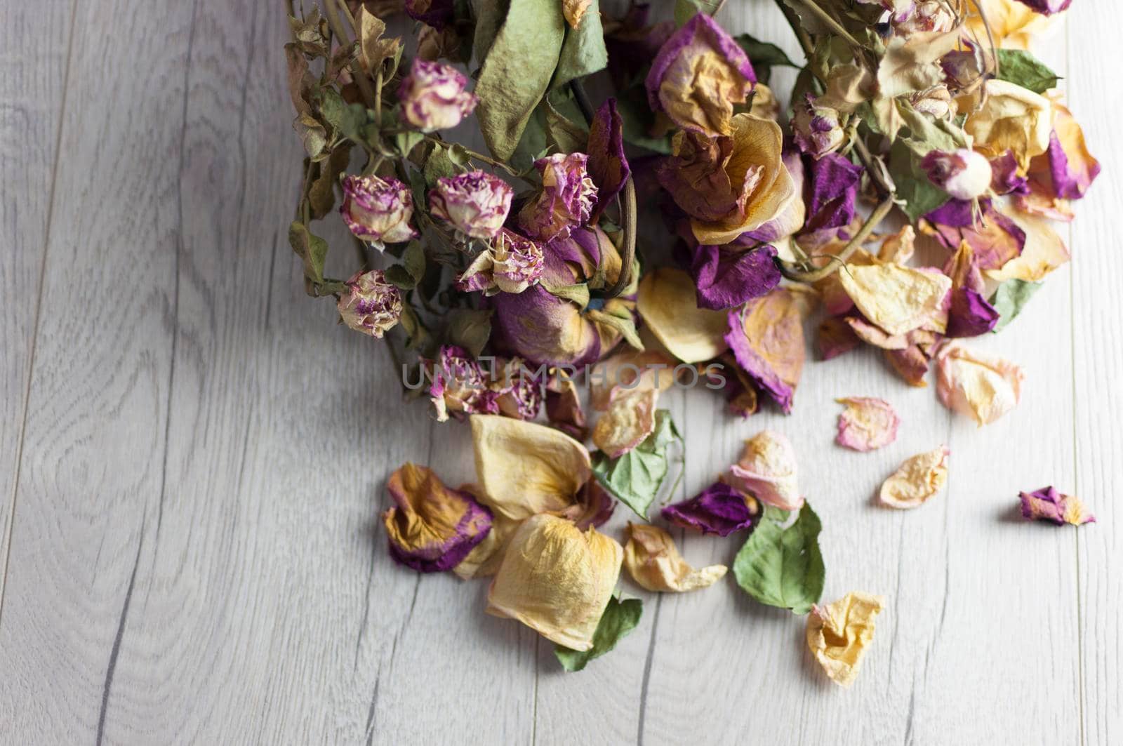 bouquet dried roses on wood background with copy space