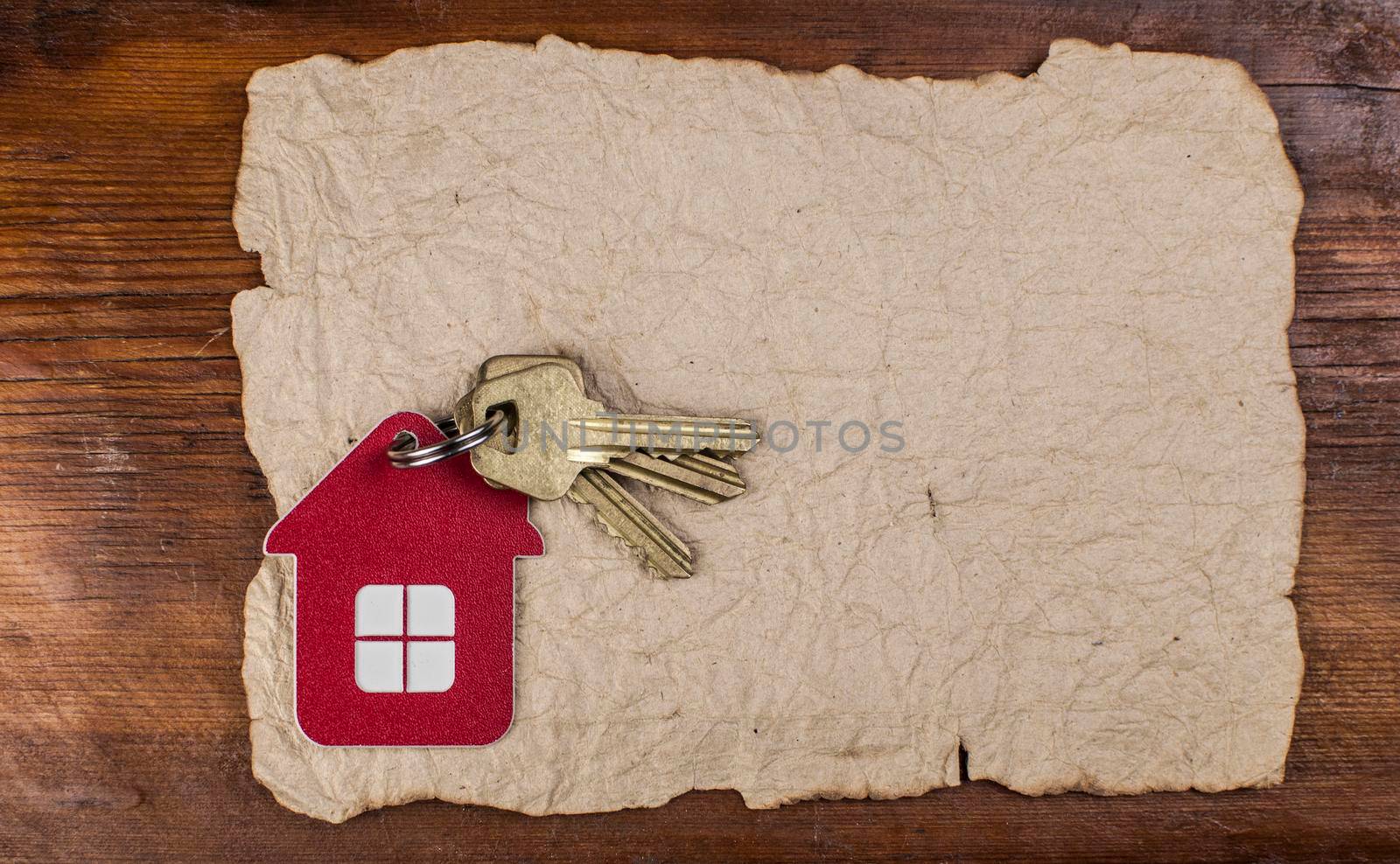 Symbol of the house with golden keys on vintage wooden background 