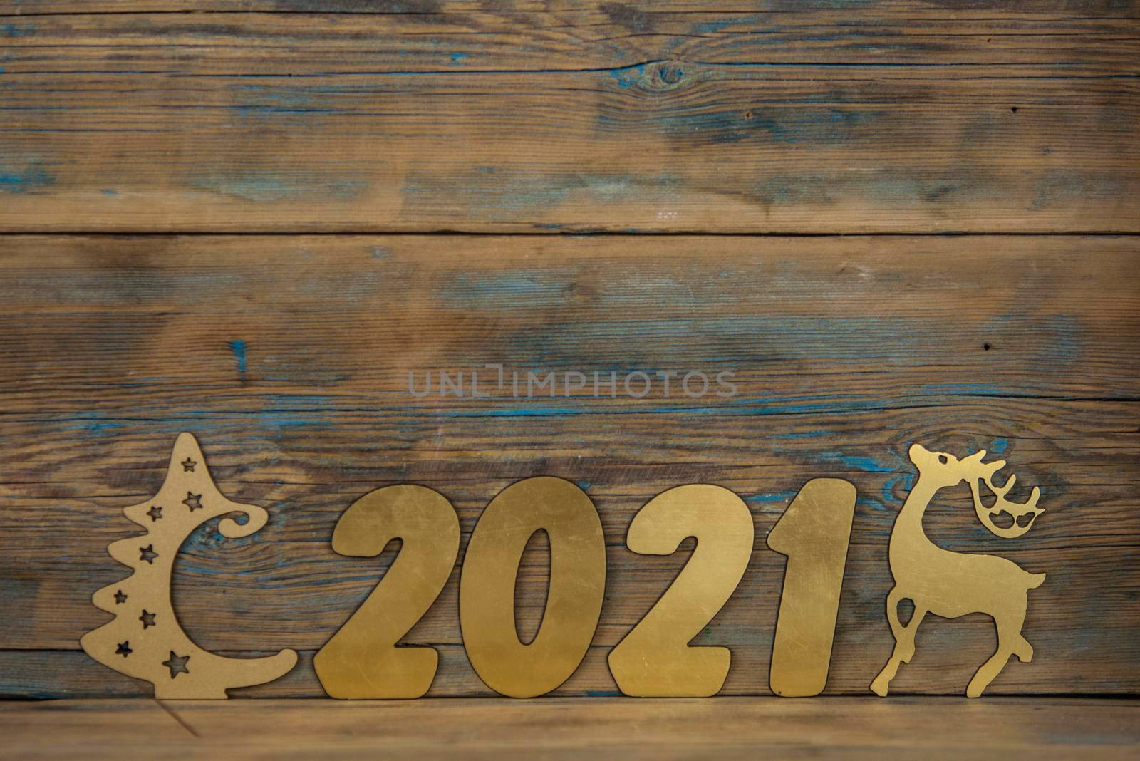 2021 happy new year gold number on wood table with space for text. 