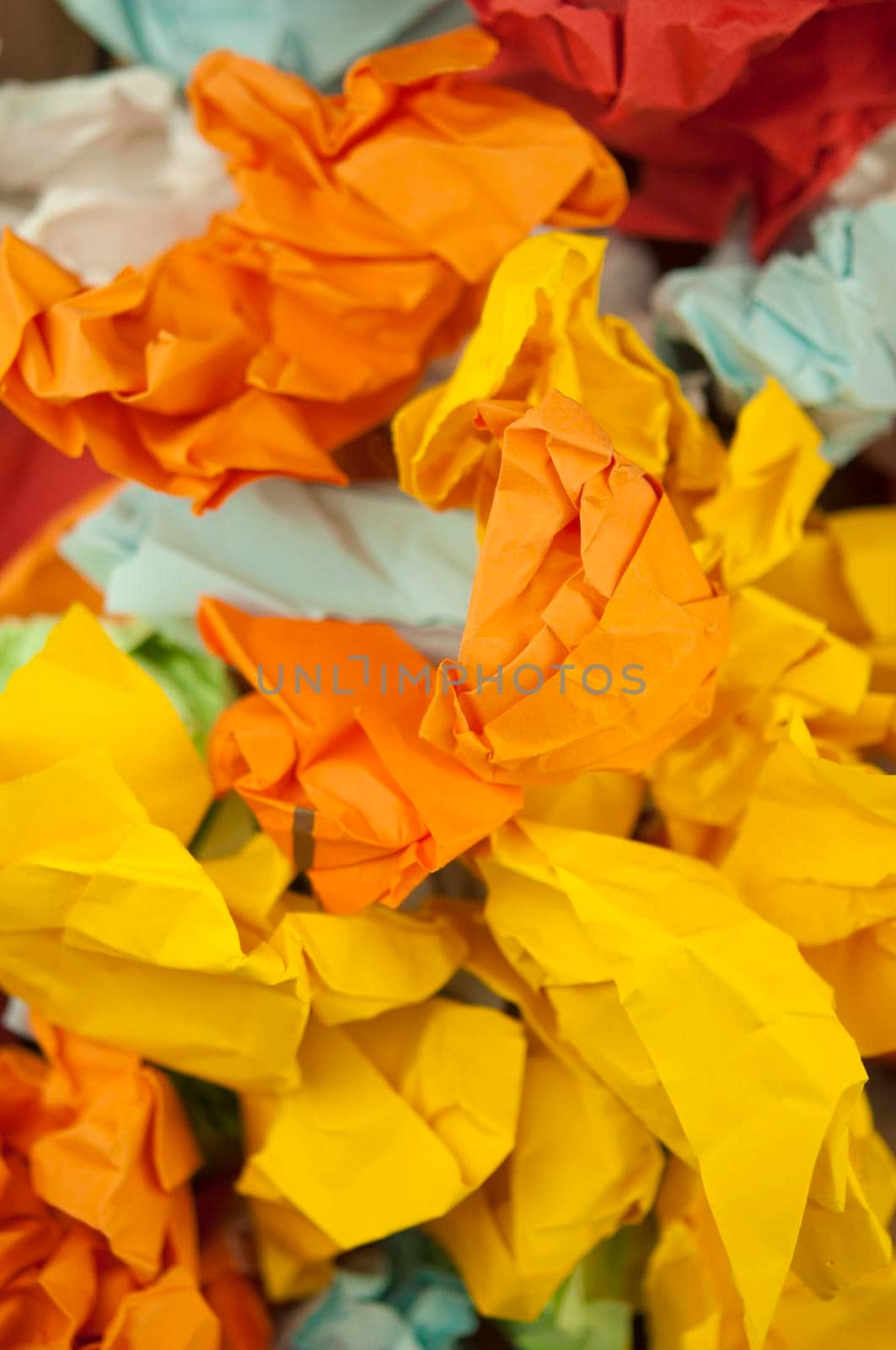 Heap crumpled colorful paper background. Close-up.