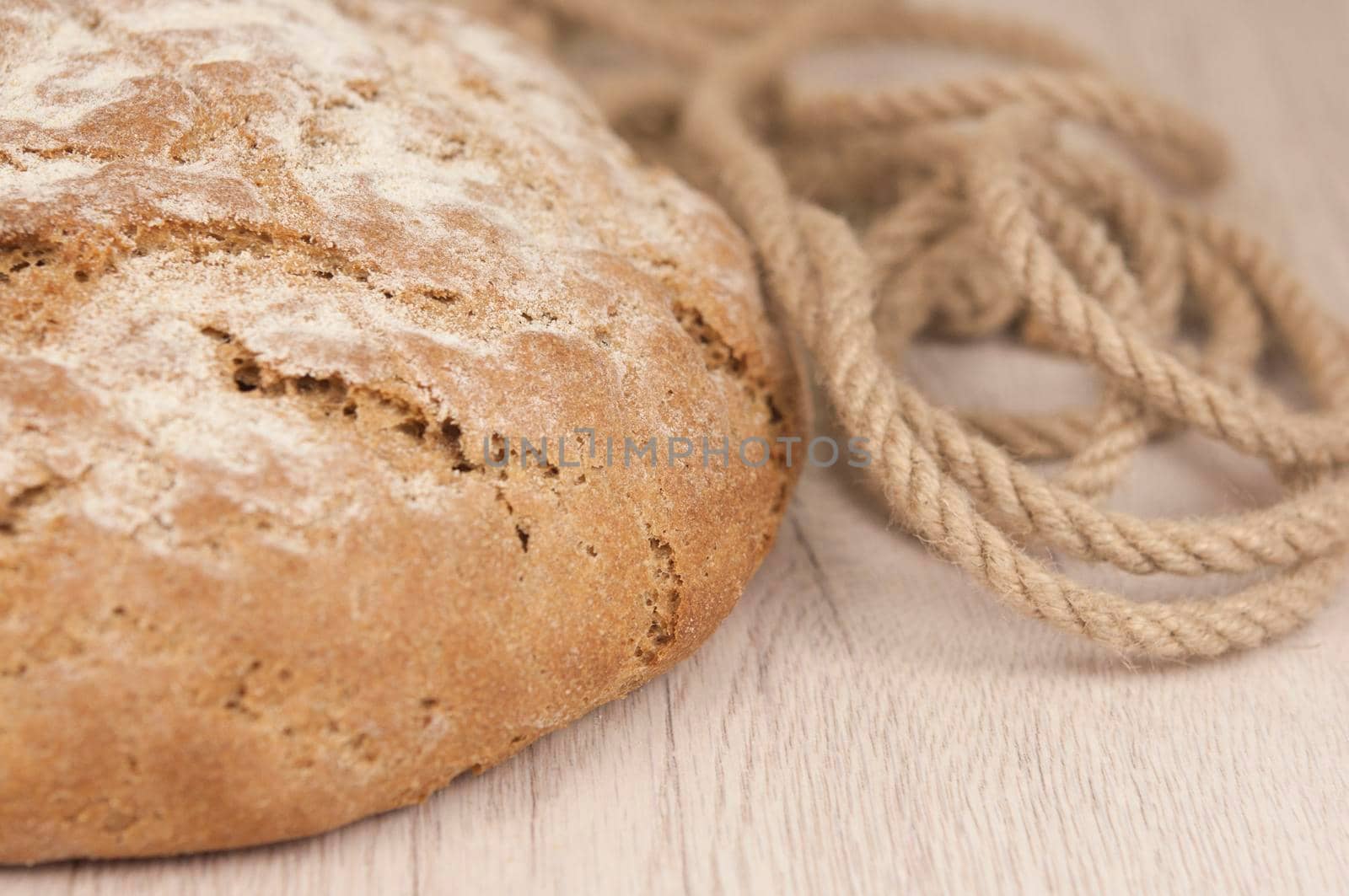 Homemade round loaf of freshly backed sourdough bread, with copy space