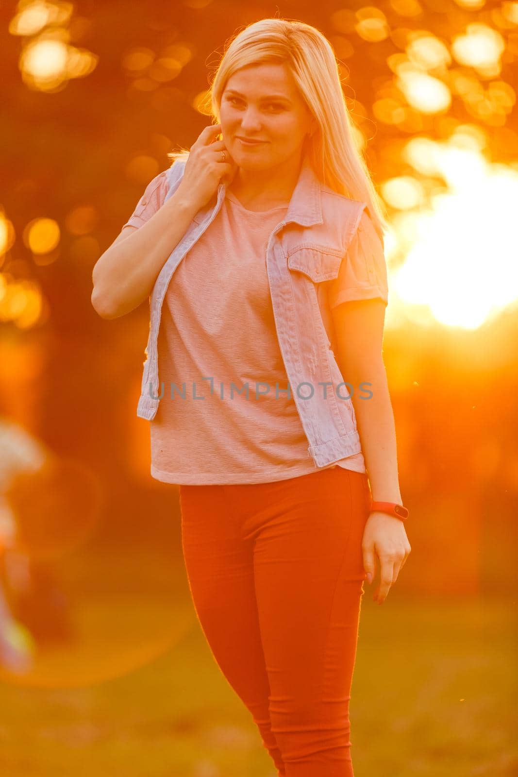 Young woman on field over sunset by Andelov13