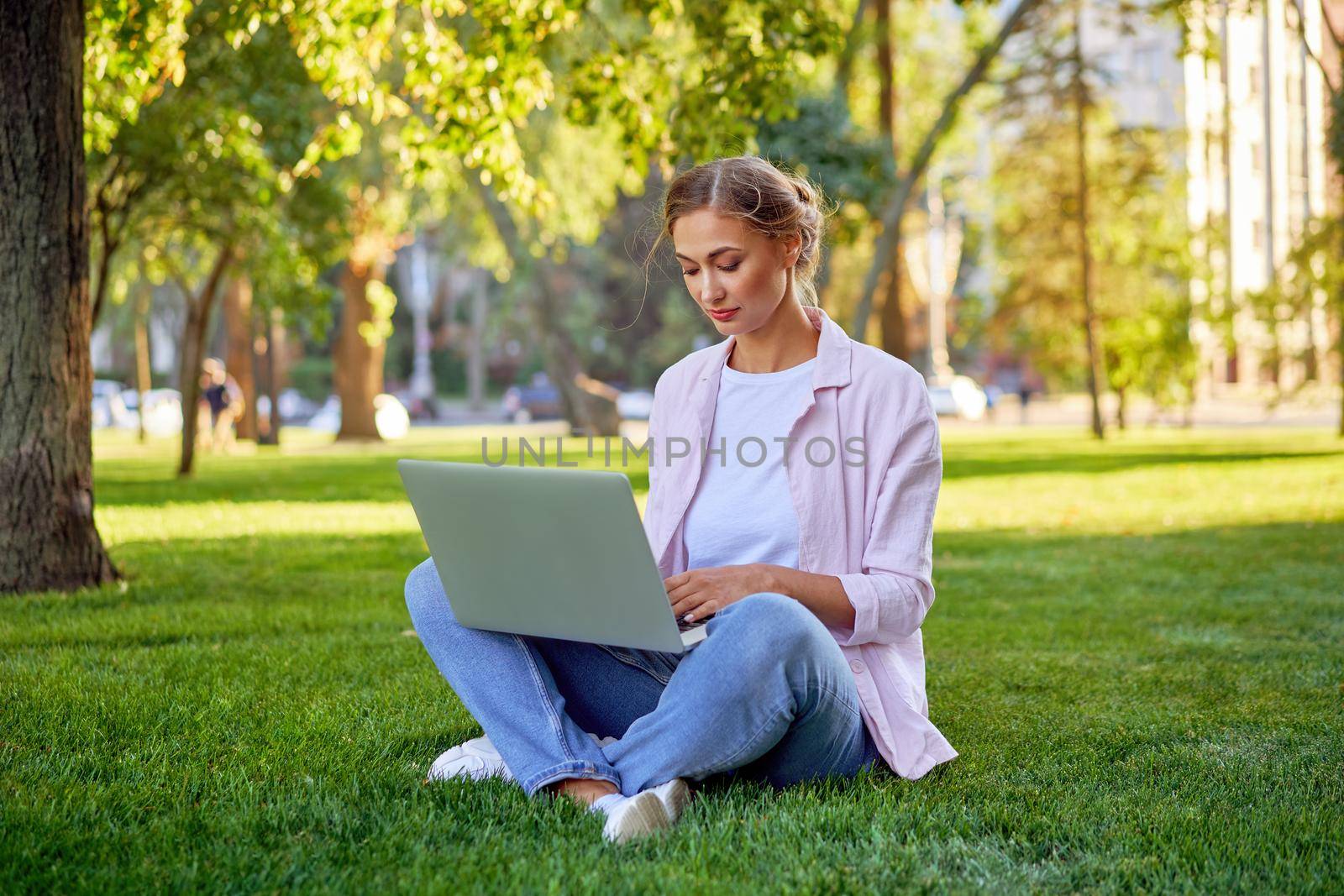 Businesswoman sitting grass summer park using laptop Business persone working remote. Outdoors Successful european caucasian woman freelancer make video call teacher study work online lessons