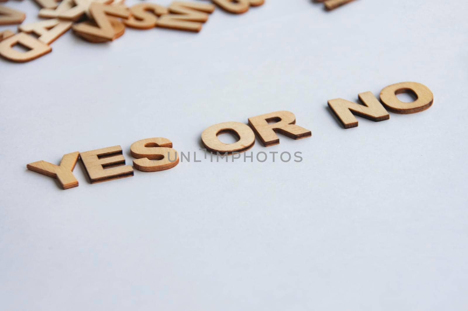 Yes or No wooden text on while cover background.