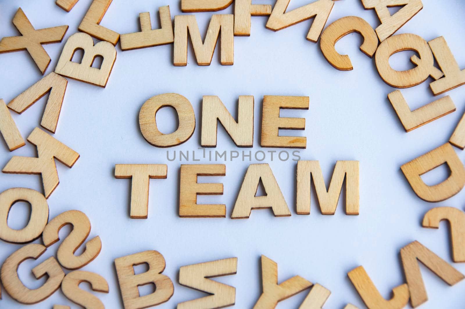 One team wooden text on while cover background. Teamwork concept.