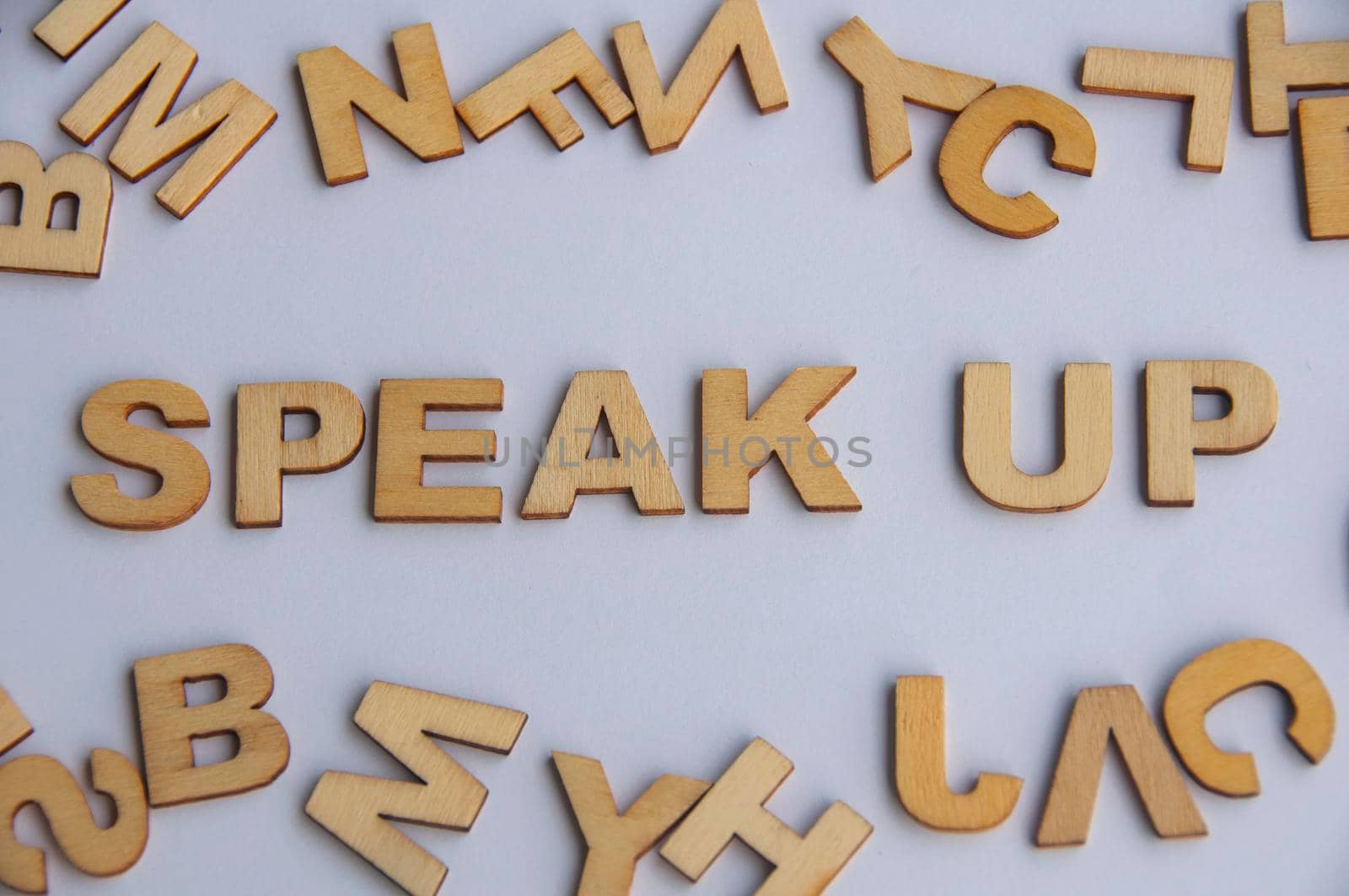 Speak up wooden text on while cover background. Courage concept.