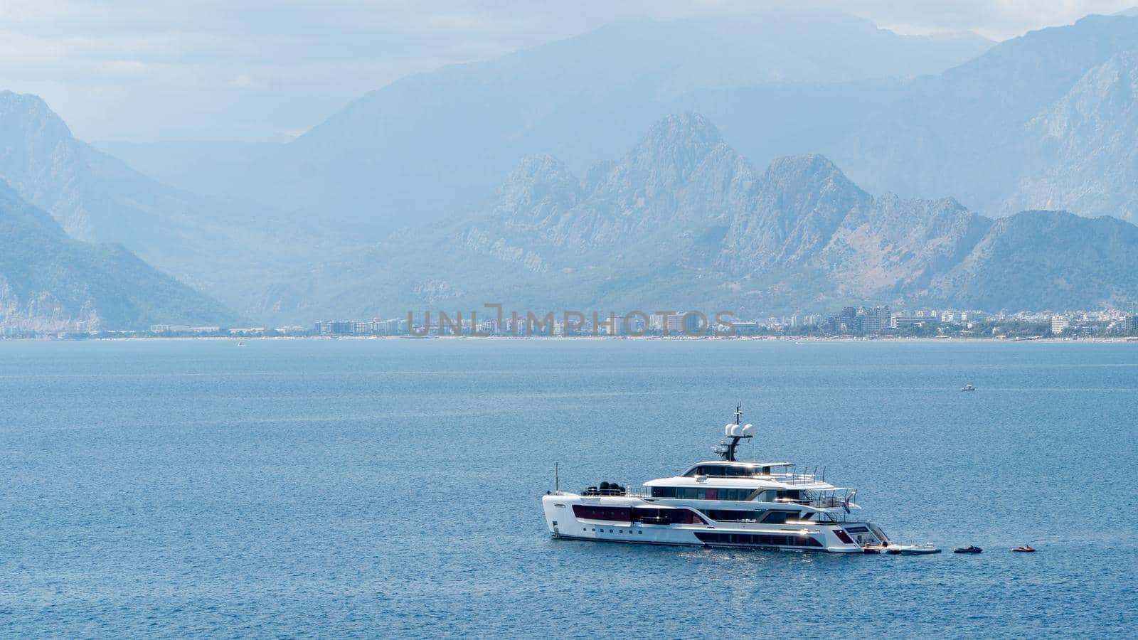 Ship yacht in the sea among the mountains in the fog. High quality photo