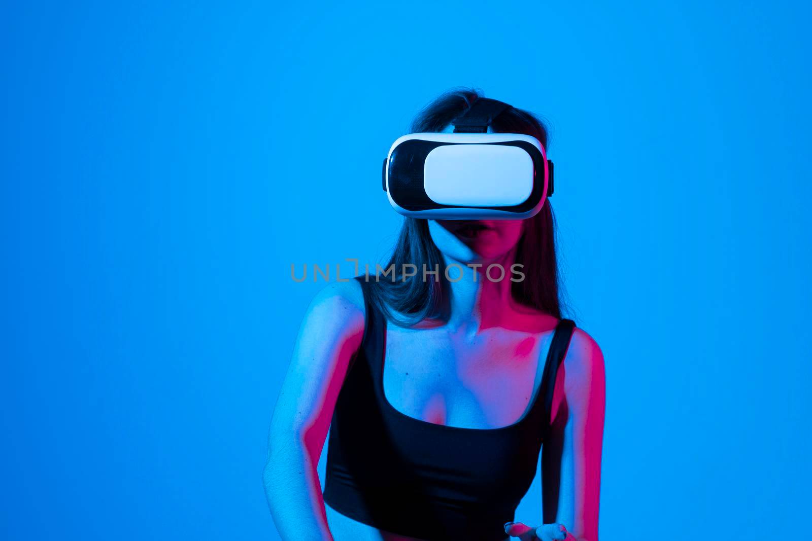 Young brunette woman in vr glasses and workung in virtual simulated world. Future technology digital cyber universe