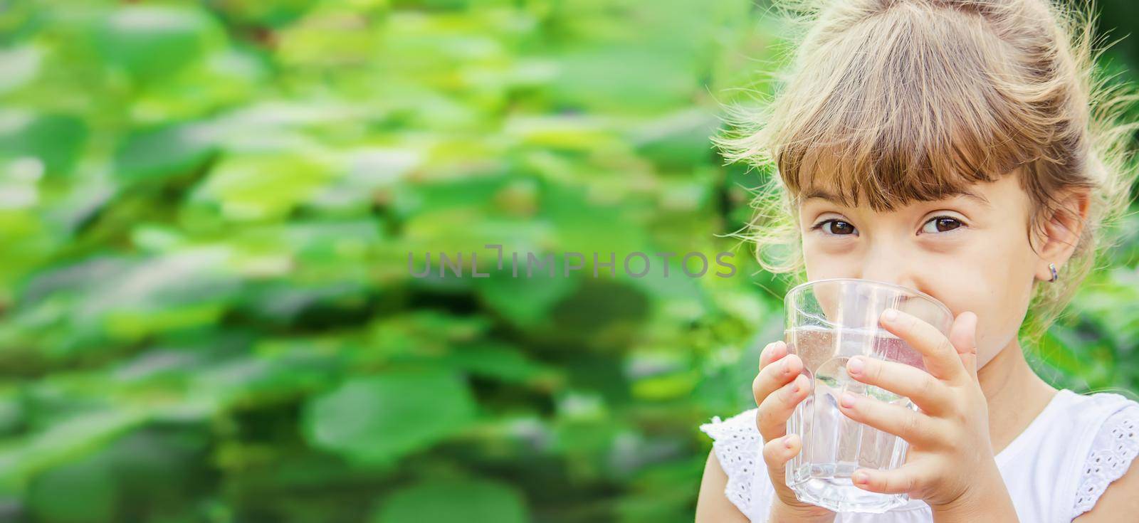 child glass of water. selective focus. nature. by yanadjana
