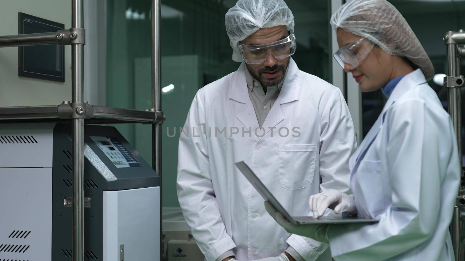 Two scientist in professional uniform working in laboratory for chemical and biomedical experiment