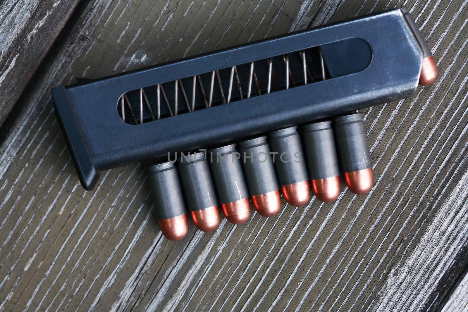 Pistol Cartridges On Wood by kvkirillov