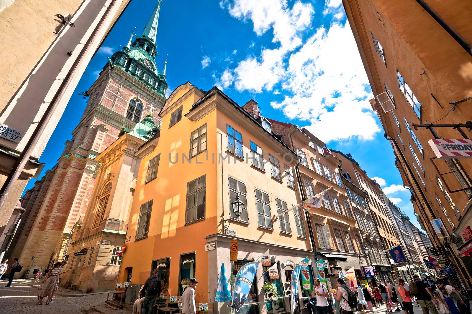 Stockholm, Sweden, August 26 2022: Busy tourist street of Stockholm old town. Shops and restaurants, and stunting architecture view.