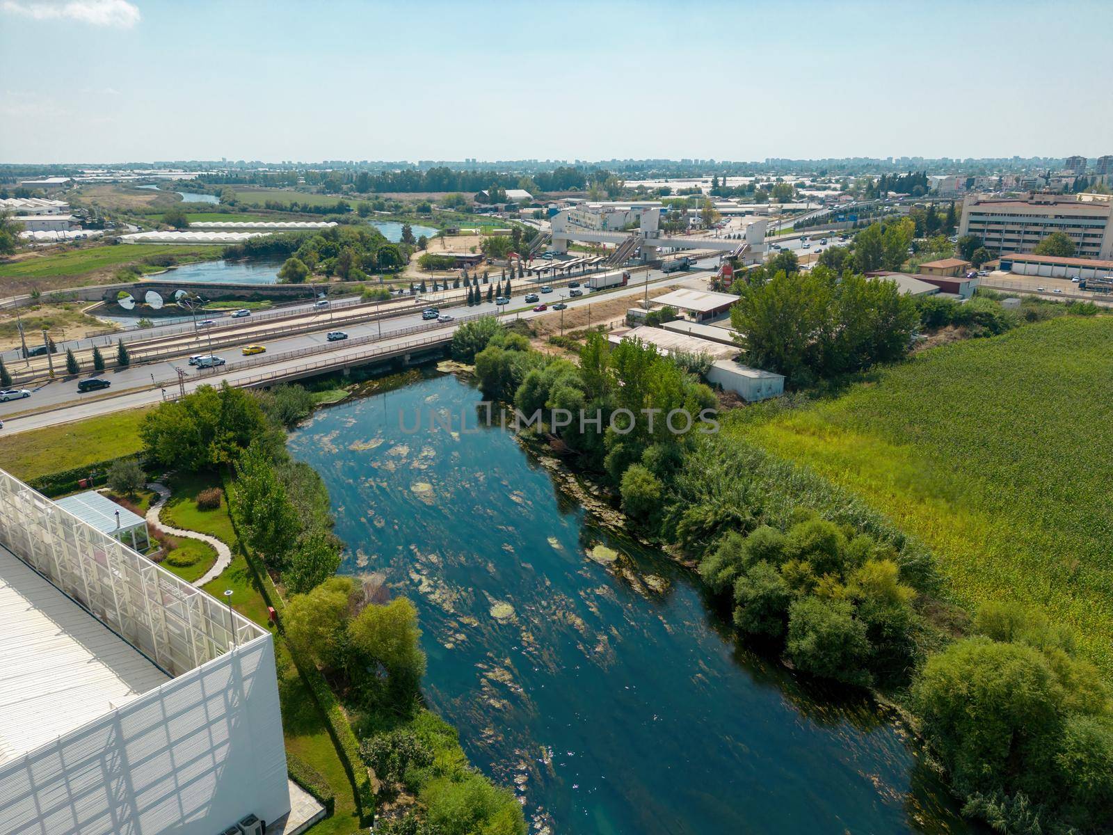 Aerial view of riverside highway on a sunny day by Sonat