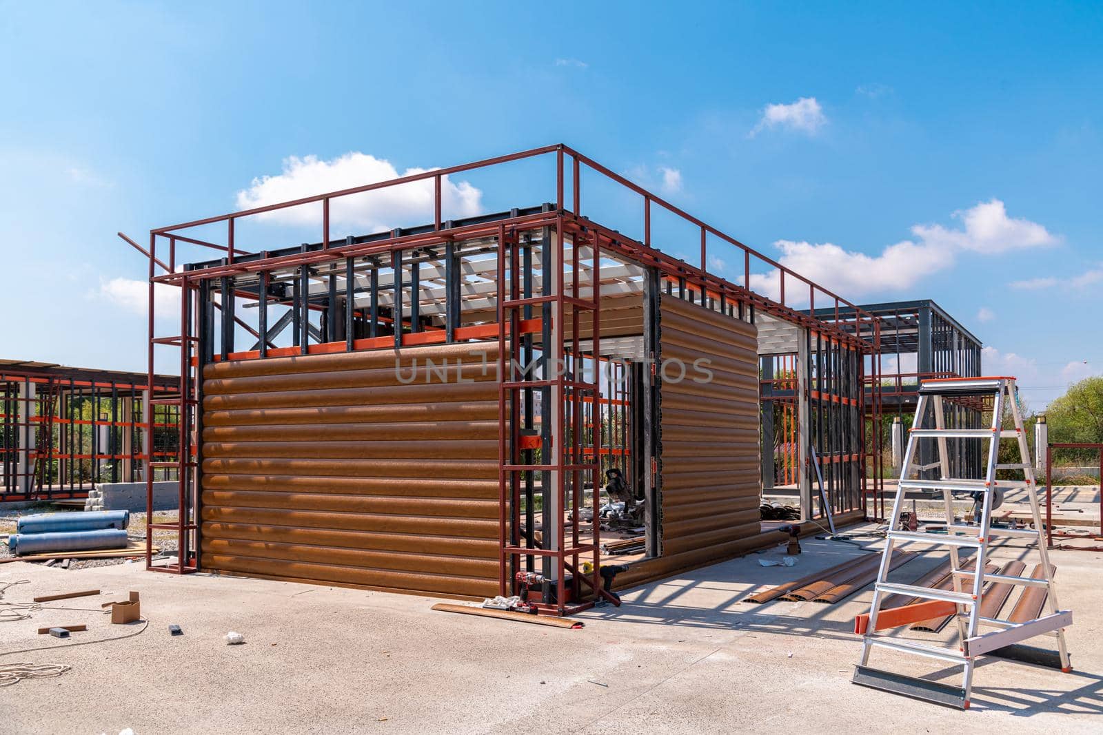 Metal frame of newly built building. Construction of a new tiny house. Selective focus