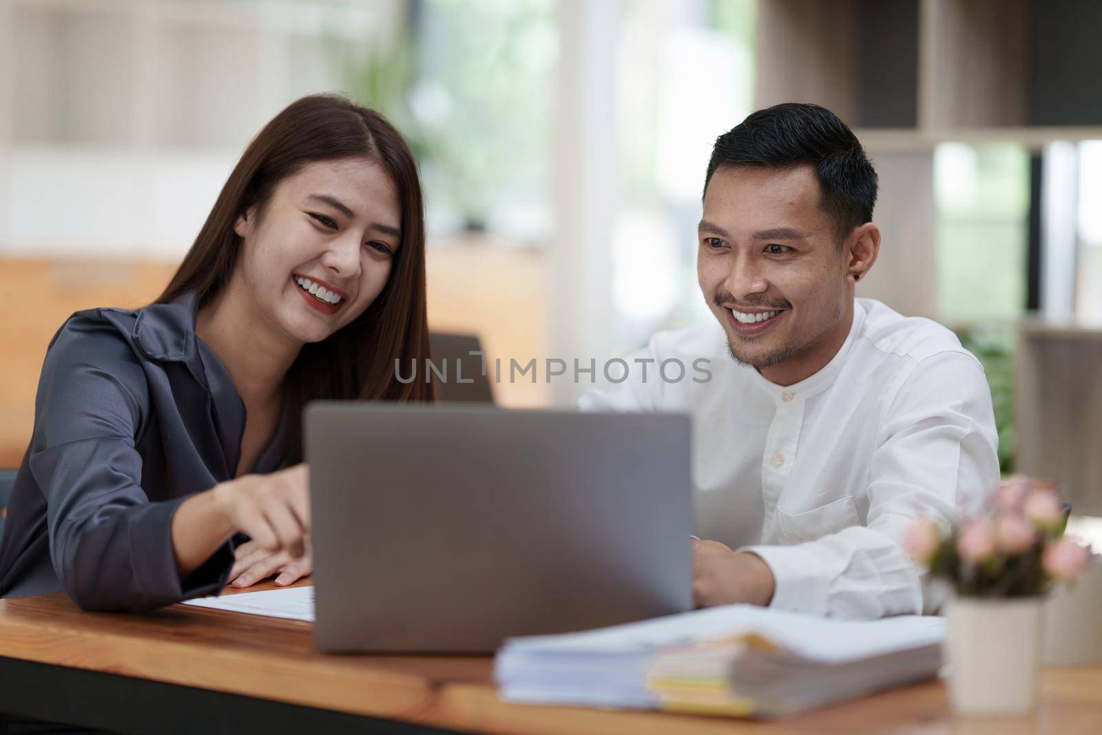 Two asian fund manager brainstorming new business project finance investment concept.