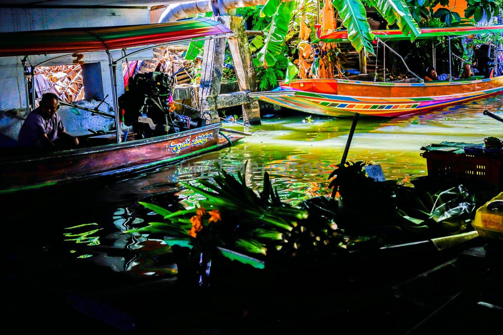 Local peoples sell fruits, food and souvenirs at floating market famous tourist attraction in Thailand