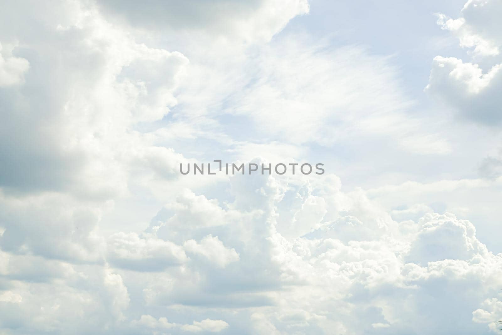 Abstract nature background with clouds in light tonality. White cumulus clouds