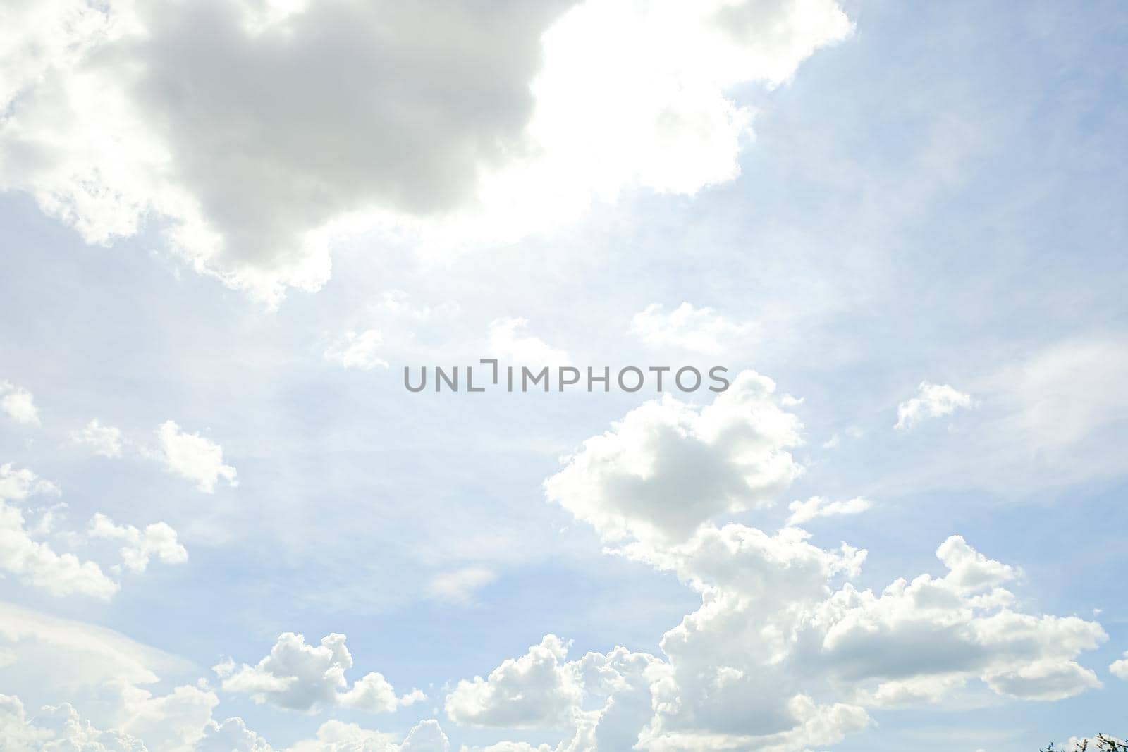 Abstract nature background with clouds in light tonality. White cumulus clouds