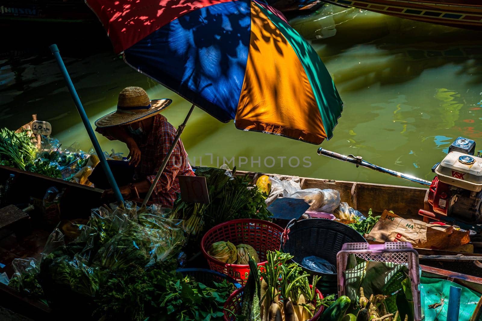 Local peoples sell fruits, food and souvenirs at floating market famous tourist attraction in Thailand
