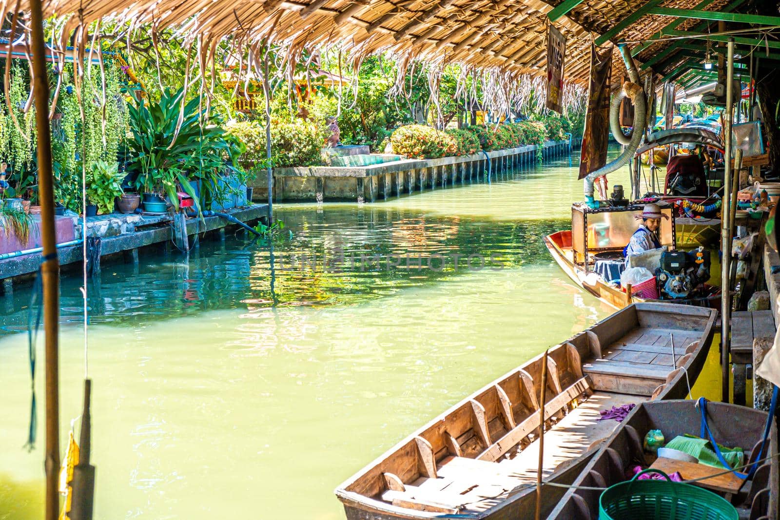 Local peoples sell fruits, food and souvenirs at floating market famous tourist attraction in Thailand