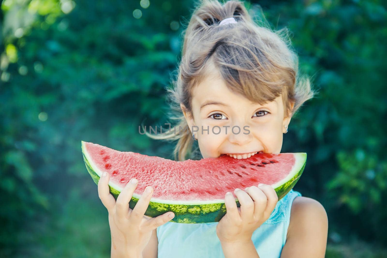 A child eats watermelon. Selective focus. nature.